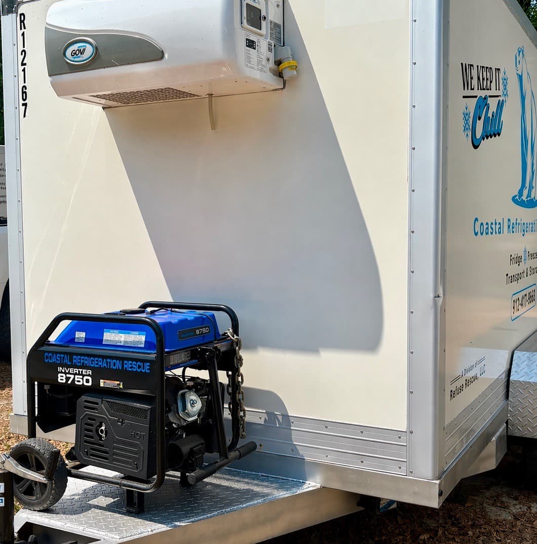 Branded backup generator powering a Coastal Refrigeration Rescue trailer Coastal Refrigeration Rescue branded inverter generator powering a refrigerated trailer on site